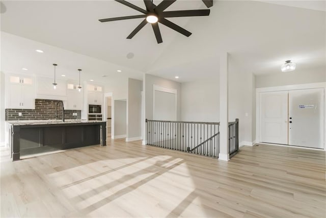 3116 SW Summit View Trl, Lees Summit, MO 64082 - kitchen featuring white cabinets, light wood finished floors, ceiling fan, open floor plan, and glass insert cabinets