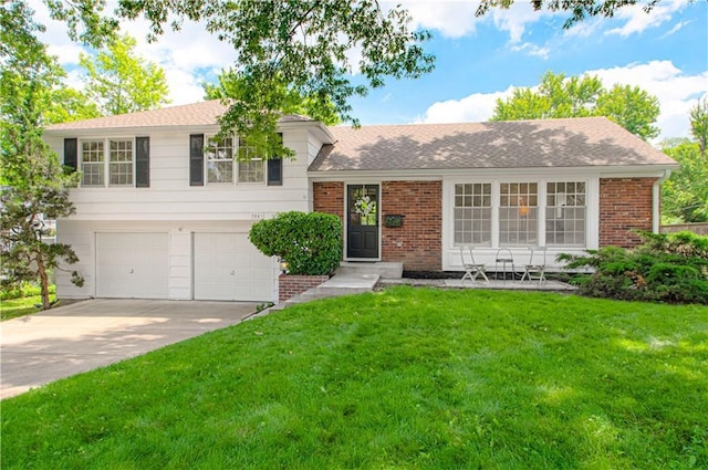 7801 Colonial Dr, Prairie Village, KS 66208 - split level home featuring a front yard, a garage, concrete driveway, and brick siding
