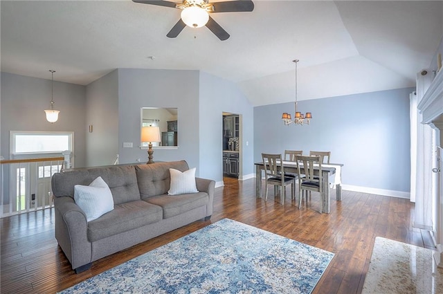 23600 W 59th St, Shawnee, KS 66226 - living area with a ceiling fan, dark wood-style floors, baseboards, vaulted ceiling, and a chandelier