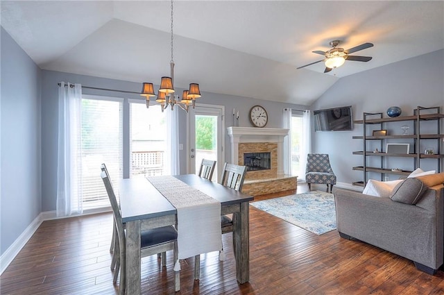 23600 W 59th St, Shawnee, KS 66226 - dining area with vaulted ceiling, a stone fireplace, a chandelier, baseboards, and dark wood finished floors