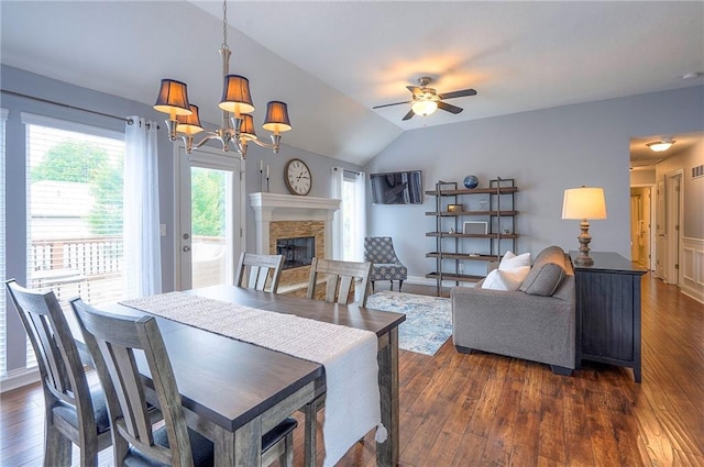 23600 W 59th St, Shawnee, KS 66226 - dining area with dark wood-style flooring, a ceiling fan, a stone fireplace, lofted ceiling, and a chandelier