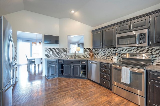 23600 W 59th St, Shawnee, KS 66226 - kitchen with appliances with stainless steel finishes, vaulted ceiling, a sink, backsplash, and dark wood-style flooring