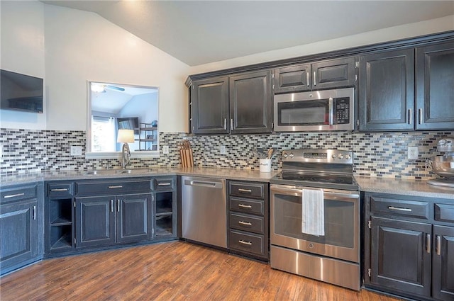 23600 W 59th St, Shawnee, KS 66226 - kitchen featuring stainless steel appliances, vaulted ceiling, backsplash, a sink, and dark wood finished floors