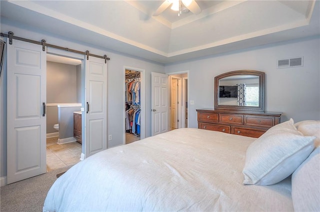 23600 W 59th St, Shawnee, KS 66226 - bedroom with a barn door, a raised ceiling, a spacious closet, a closet, and connected bathroom