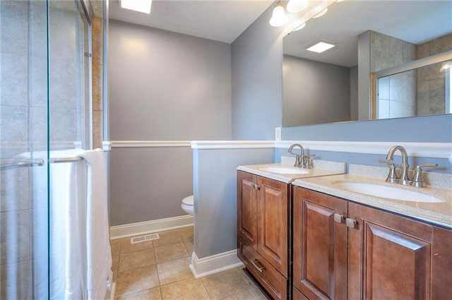 23600 W 59th St, Shawnee, KS 66226 - full bathroom featuring double vanity, tile patterned floors, toilet, baseboards, and a tile shower