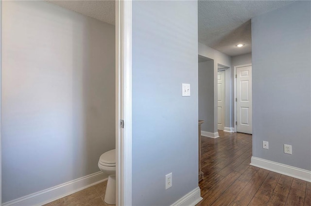 23600 W 59th St, Shawnee, KS 66226 - bathroom featuring a textured ceiling, toilet, baseboards, and wood finished floors
