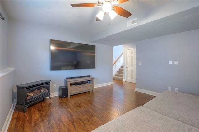23600 W 59th St, Shawnee, KS 66226 - living area with a wood stove, stairway, hardwood / wood-style floors, a ceiling fan, and baseboards