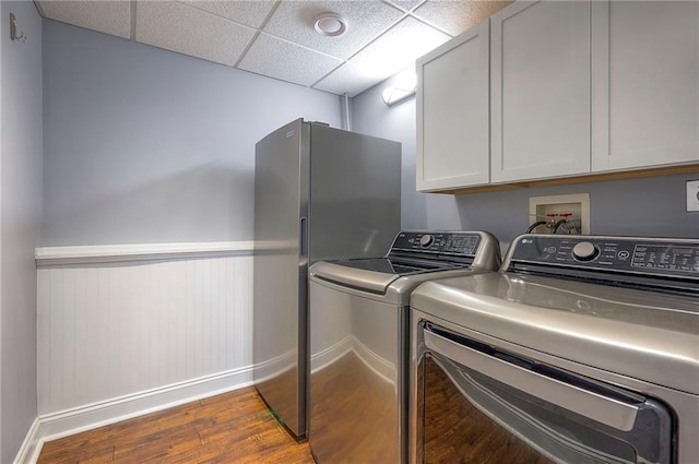 23600 W 59th St, Shawnee, KS 66226 - washroom with dark wood-style floors, baseboards, separate washer and dryer, and cabinet space