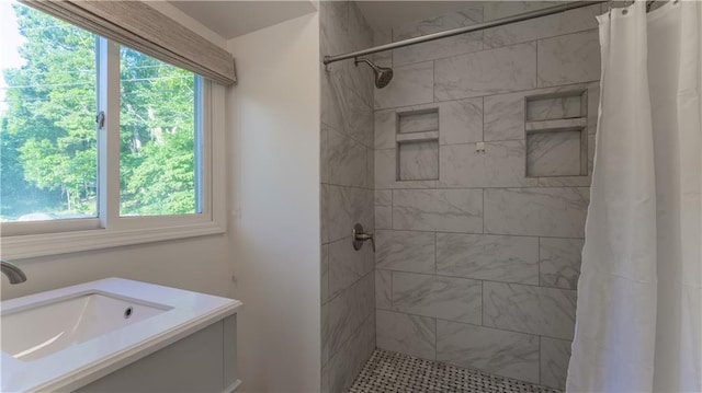 1145 Camp Branch Rd, Sunrise Beach, MO 65079 - bathroom featuring a tile shower, healthy amount of natural light, and vanity