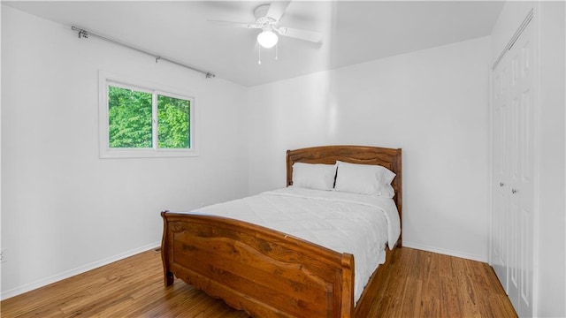 1145 Camp Branch Rd, Sunrise Beach, MO 65079 - bedroom with a closet, wood finished floors, and baseboards