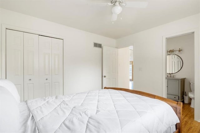 1145 Camp Branch Rd, Sunrise Beach, MO 65079 - bedroom with a closet, wood finished floors, and ceiling fan