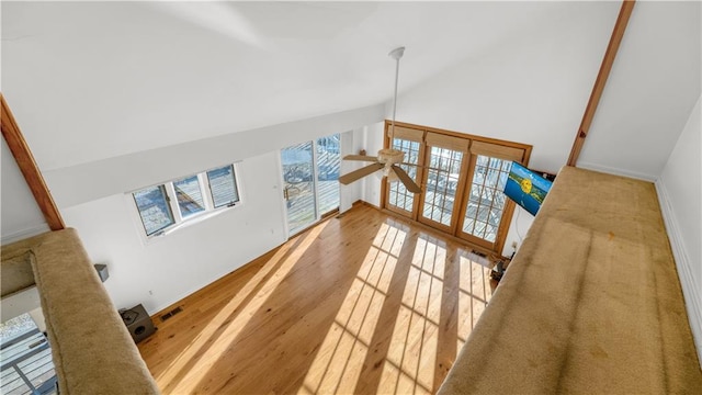 1145 Camp Branch Rd, Sunrise Beach, MO 65079 - unfurnished living room featuring ceiling fan, wood finished floors, and high vaulted ceiling
