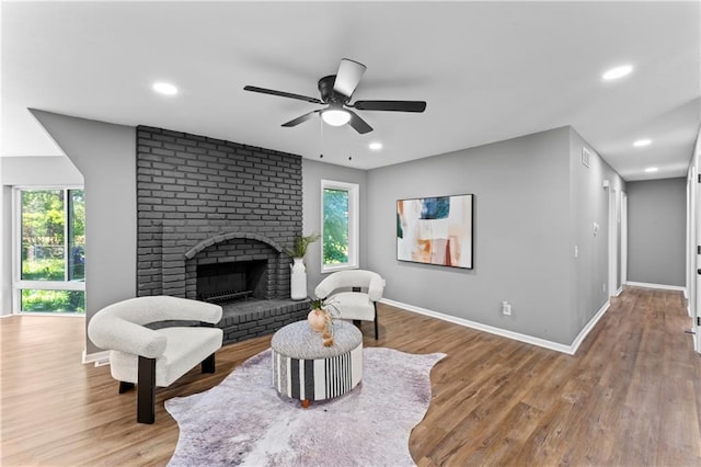 2081 Willow Ln, Excelsior Springs, MO 64024 - living area featuring a ceiling fan, healthy amount of natural light, a fireplace, wood finished floors, and recessed lighting