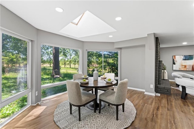 2081 Willow Ln, Excelsior Springs, MO 64024 - dining area with a skylight, plenty of natural light, wood finished floors, and recessed lighting