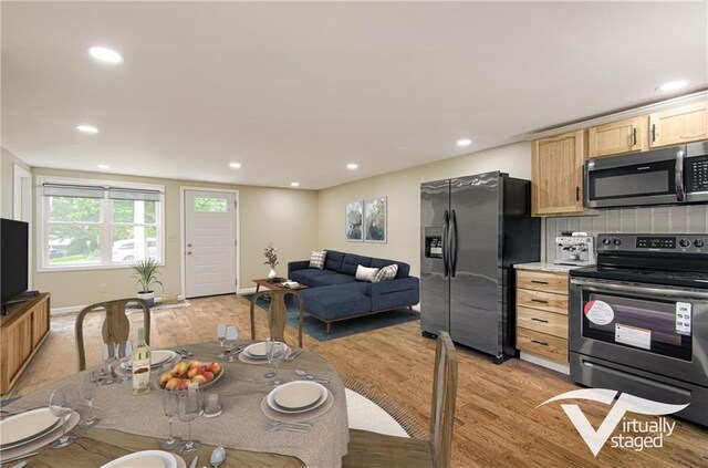 5539 NW Adrian Ave, Houston Lake, MO 64151 - kitchen with appliances with stainless steel finishes, light wood-style floors, light brown cabinetry, recessed lighting, and open floor plan