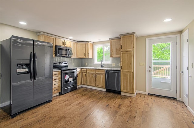 5539 NW Adrian Ave, Houston Lake, MO 64151 - kitchen featuring black appliances, light countertops, tasteful backsplash, wood finished floors, and recessed lighting