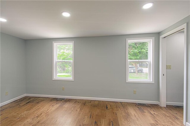 5539 NW Adrian Ave, Houston Lake, MO 64151 - spare room featuring healthy amount of natural light, wood finished floors, and recessed lighting