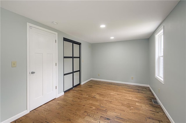 5539 NW Adrian Ave, Houston Lake, MO 64151 - unfurnished bedroom with wood finished floors and recessed lighting