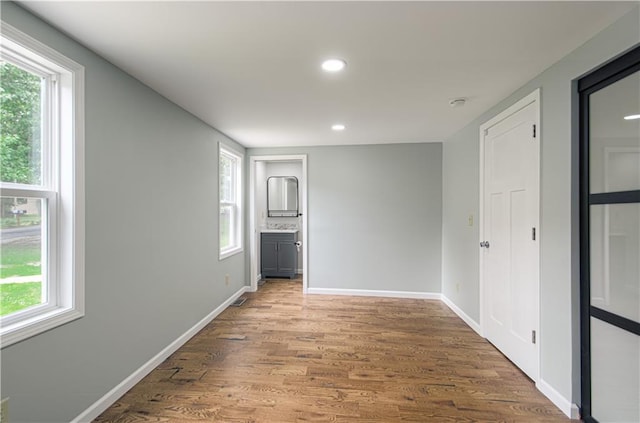 5539 NW Adrian Ave, Houston Lake, MO 64151 - empty room with plenty of natural light, wood finished floors, recessed lighting, and a smoke detector