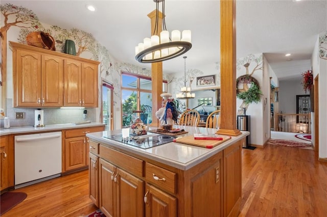 15471 Cedar Ln, Basehor, KS 66007 - kitchen with dishwasher, a chandelier, black electric stovetop, light wood-style floors, and a kitchen island