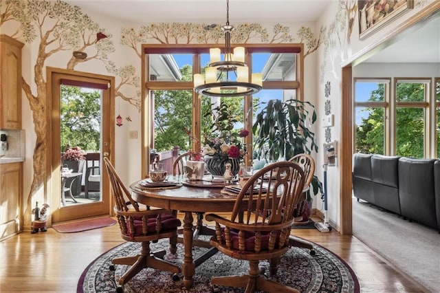 15471 Cedar Ln, Basehor, KS 66007 - dining space with a chandelier, light wood finished floors, and wallpapered walls
