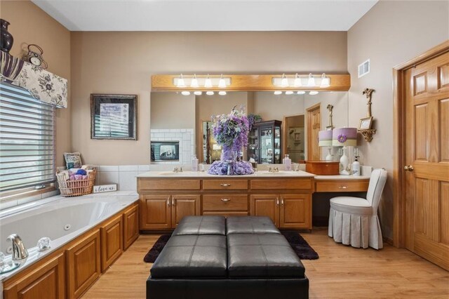15471 Cedar Ln, Basehor, KS 66007 - bathroom with double vanity, wood finished floors, and a whirlpool tub