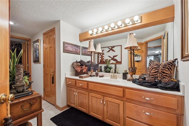 15471 Cedar Ln, Basehor, KS 66007 - bathroom featuring vanity, a textured ceiling, and tile patterned flooring