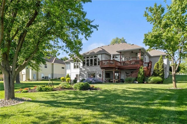 15471 Cedar Ln, Basehor, KS 66007 - back of house with a deck, a yard, ceiling fan, and stairway