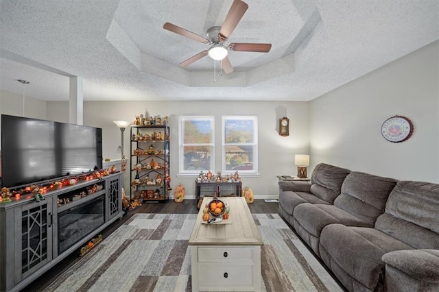 3620 S Northern Blvd, Independence, MO 64052 - living room with a textured ceiling, ceiling fan, wood finished floors, and baseboards