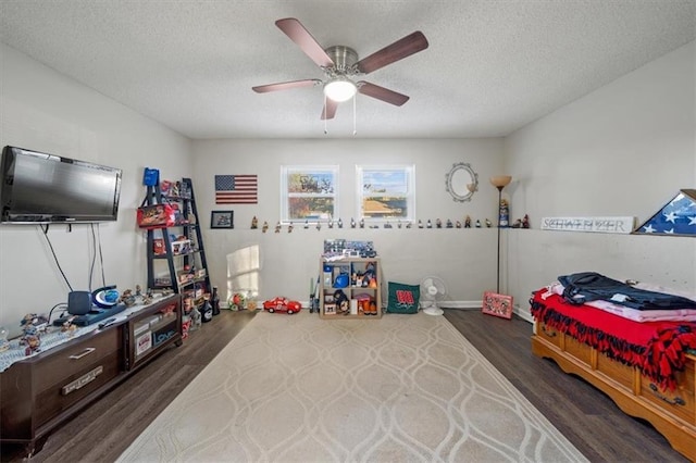 3620 S Northern Blvd, Independence, MO 64052 - playroom featuring dark wood-style floors, ceiling fan, and a textured ceiling