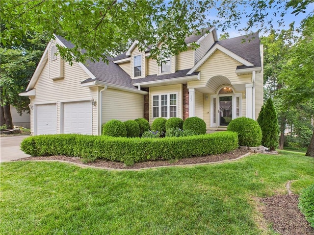 503 Quail Trl, Warrensburg, MO 64093 - traditional home with a front yard, concrete driveway, a shingled roof, and an attached garage