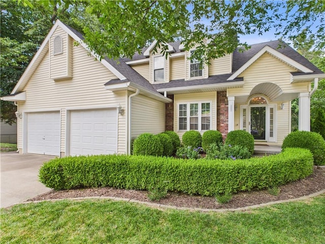 503 Quail Trl, Warrensburg, MO 64093 - view of front of house with concrete driveway, an attached garage, and roof with shingles