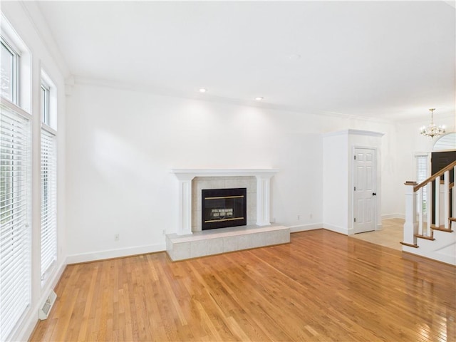 503 Quail Trl, Warrensburg, MO 64093 - unfurnished living room featuring stairway, light wood finished floors, a chandelier, and recessed lighting