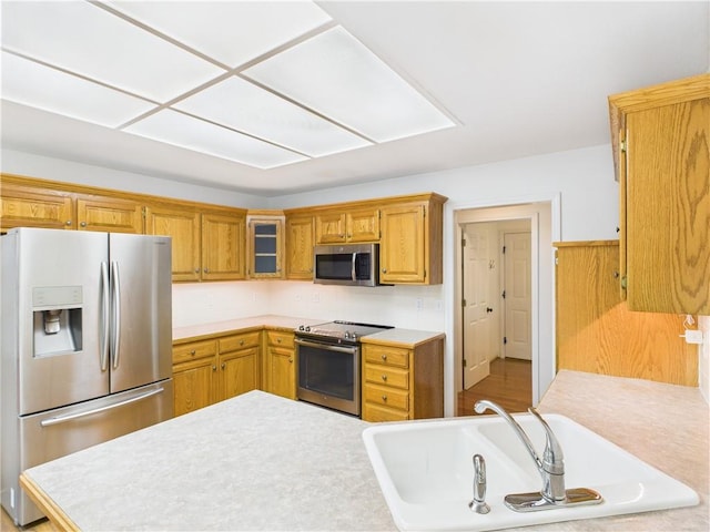 503 Quail Trl, Warrensburg, MO 64093 - kitchen featuring appliances with stainless steel finishes, light countertops, and brown cabinets