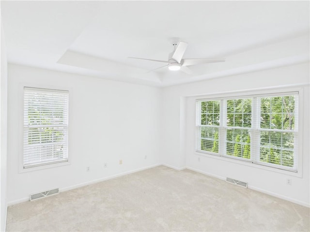 503 Quail Trl, Warrensburg, MO 64093 - unfurnished room with light colored carpet, a raised ceiling, and a ceiling fan