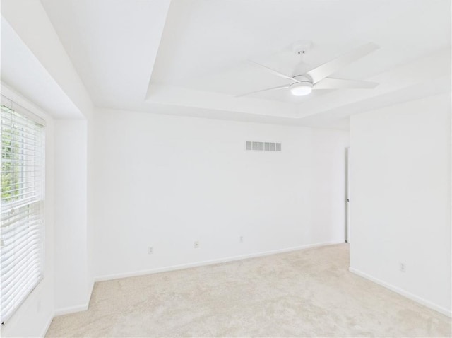 503 Quail Trl, Warrensburg, MO 64093 - empty room with a raised ceiling, light colored carpet, and a ceiling fan