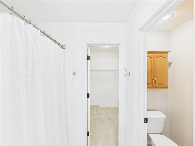 503 Quail Trl, Warrensburg, MO 64093 - full bathroom featuring a walk in closet and a shower with shower curtain