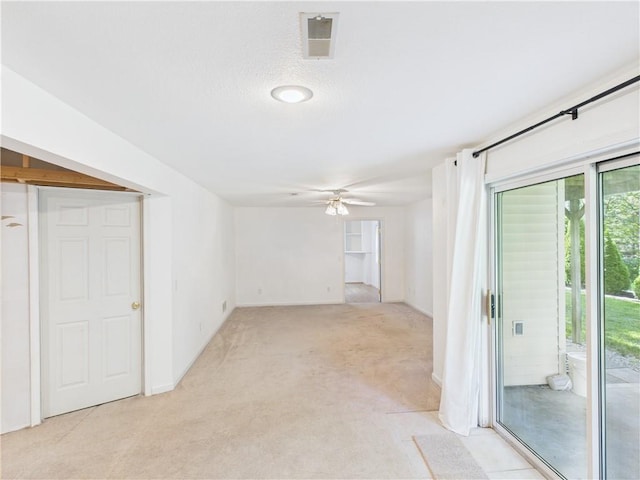 503 Quail Trl, Warrensburg, MO 64093 - unfurnished living room featuring light colored carpet and a ceiling fan