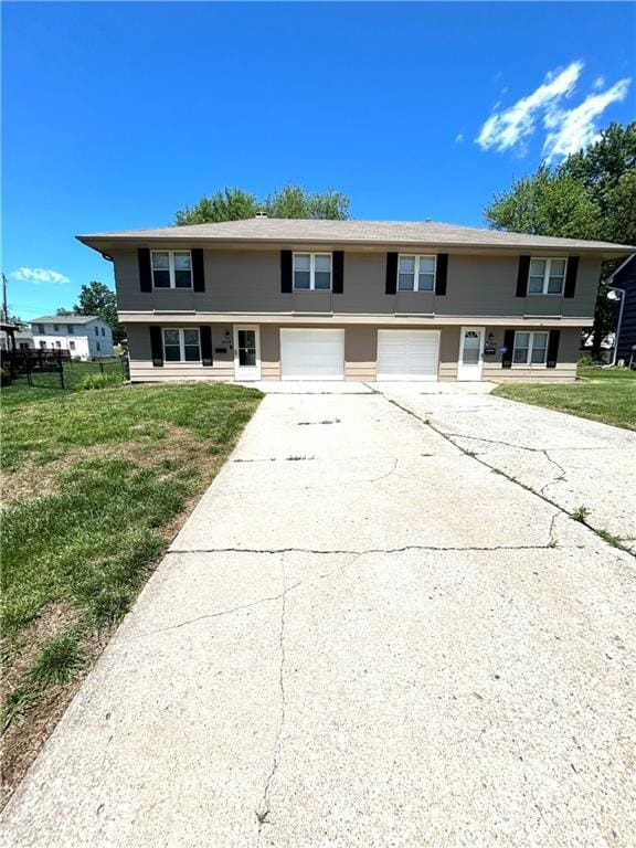3408 67th St, Kansas City, MO 64119 - view of property with a garage, concrete driveway, and a front lawn