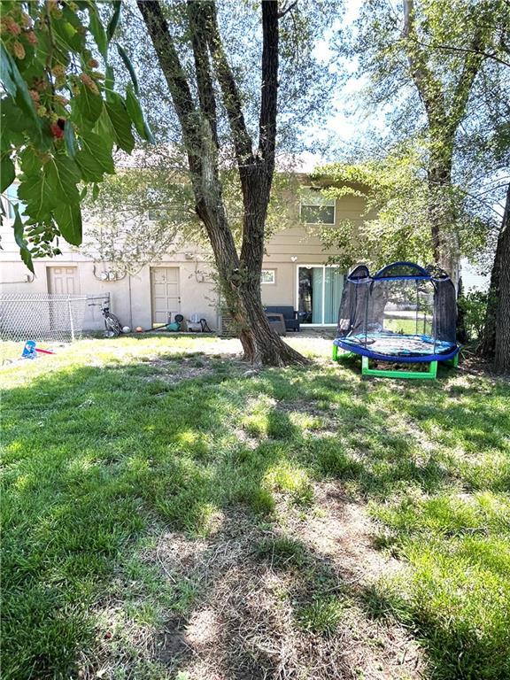 3408 67th St, Kansas City, MO 64119 - view of yard with a trampoline