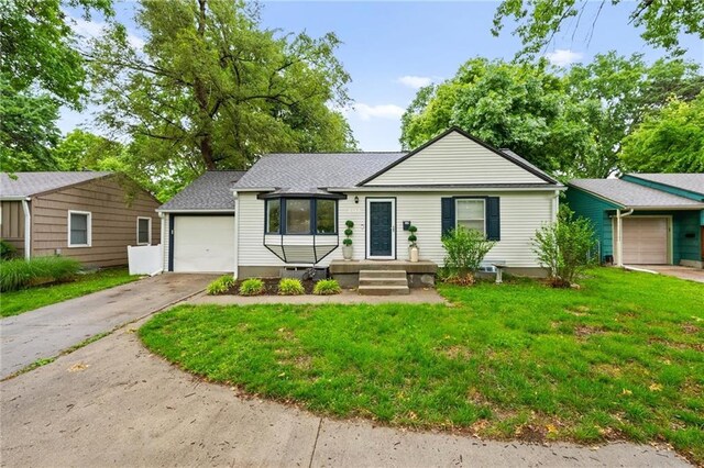 2912 W 75th St, Prairie Village, KS 66208 - ranch-style home with driveway, a front yard, an attached garage, and a shingled roof