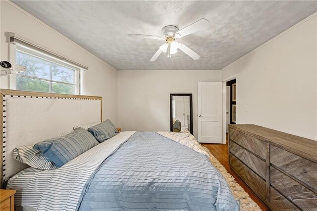2912 W 75th St, Prairie Village, KS 66208 - bedroom with wood finished floors, a ceiling fan, and a textured ceiling