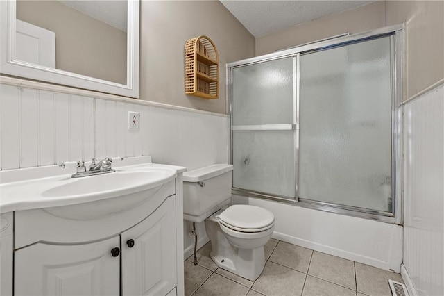 2912 W 75th St, Prairie Village, KS 66208 - full bathroom featuring vanity, a wainscoted wall, enclosed tub / shower combo, and tile patterned flooring