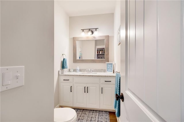 905 SE Wood Ridge Ct, Blue Springs, MO 64014 - half bath with vanity, toilet, and wood finished floors