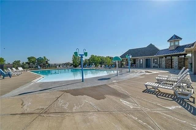 905 SE Wood Ridge Ct, Blue Springs, MO 64014 - community pool featuring a patio