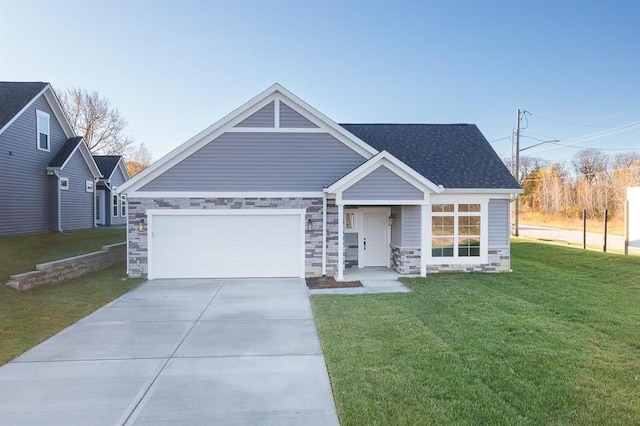 11471 Webster Ave, Kansas City, KS 66109 - view of front of property with concrete driveway, a front lawn, stone siding, an attached garage, and a shingled roof