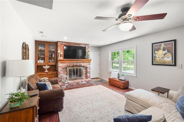 2708 Lawrence Ave, Lawrence, KS 66047 - living area featuring wood finished floors, a ceiling fan, a brick fireplace, baseboards, and recessed lighting