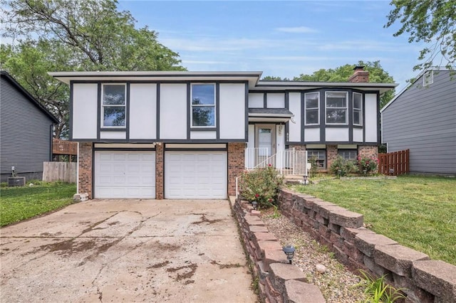 838 E 125th Ter, Olathe, KS 66061 - split foyer home with brick siding, a garage, driveway, and stucco siding