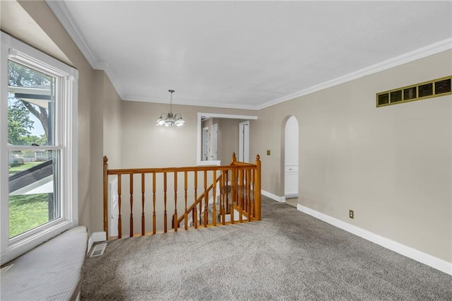 838 E 125th Ter, Olathe, KS 66061 - unfurnished room with healthy amount of natural light, arched walkways, ornamental molding, carpet, and baseboards