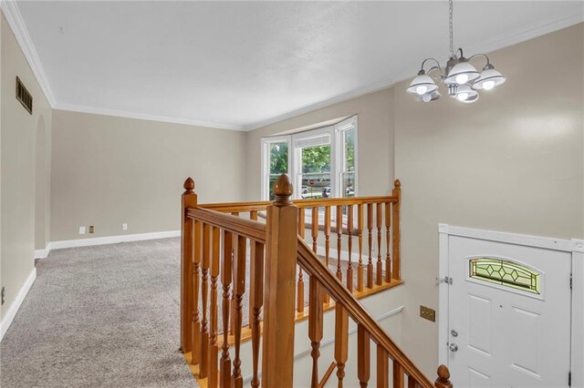 838 E 125th Ter, Olathe, KS 66061 - hall featuring an upstairs landing, a chandelier, light colored carpet, crown molding, and baseboards